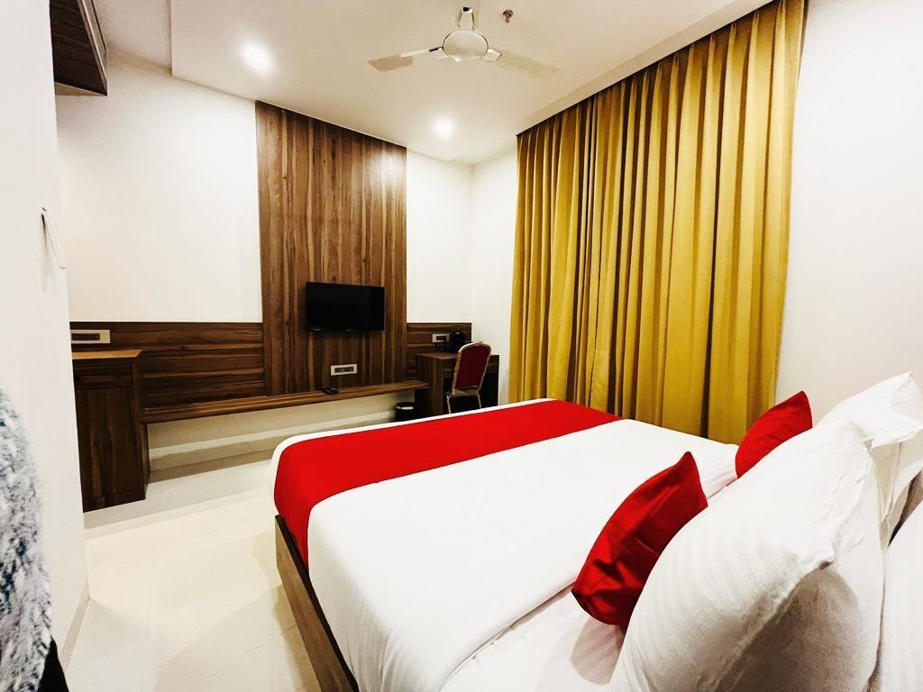 The Royal Legacy Executive Suite King Bedroom with Desk and Television